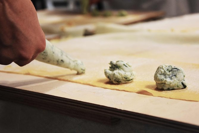 Become a Masterchef in Rome: Pasta, Ravioli and Tiramisù Class - Folding ravioli with help from the chef