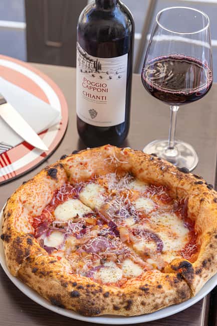 Florence: Private Pizza Making Class with Wine Tasting - Adding sauce and preparing the pizza for the oven