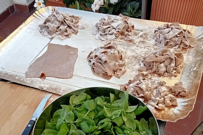 Homemade Pasta and Pesto Class with a Local Chef in Genoa - A rooftop table with a full Genoese meal