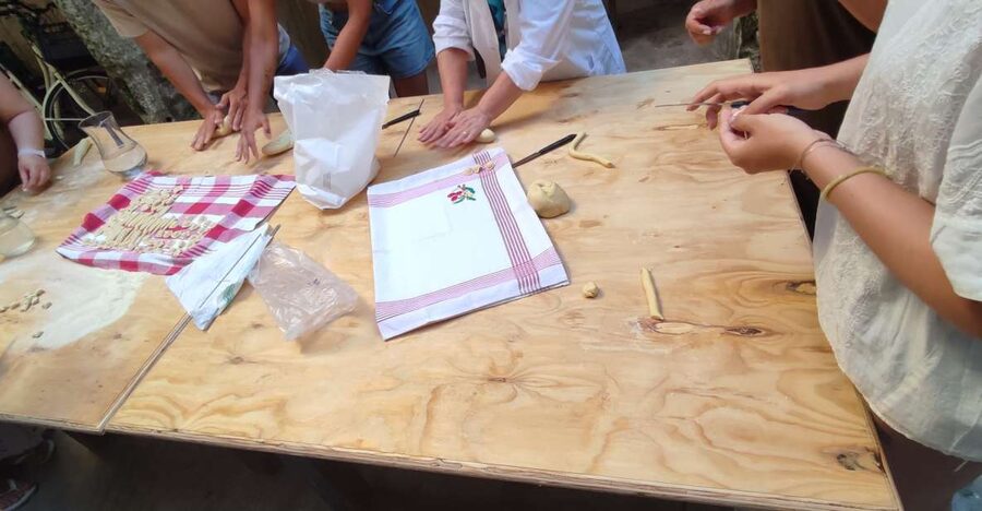 Lecce: Pasta Making Class in 1400s-Era Courtyard with Wine - Mixing flour and water with local cooks