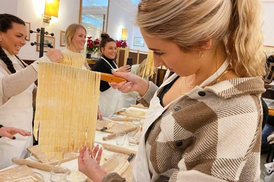 Pasta Cooking Class with Pesto Sauce Making in Rome Center - Crushing basil, nuts, and pesto ingredients