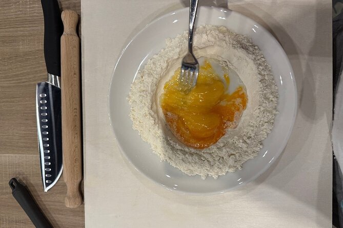 Pasta Fettuccine, Ravioli and Tiramisu Cooking Class in Florence - Rolling and cutting the fettuccine