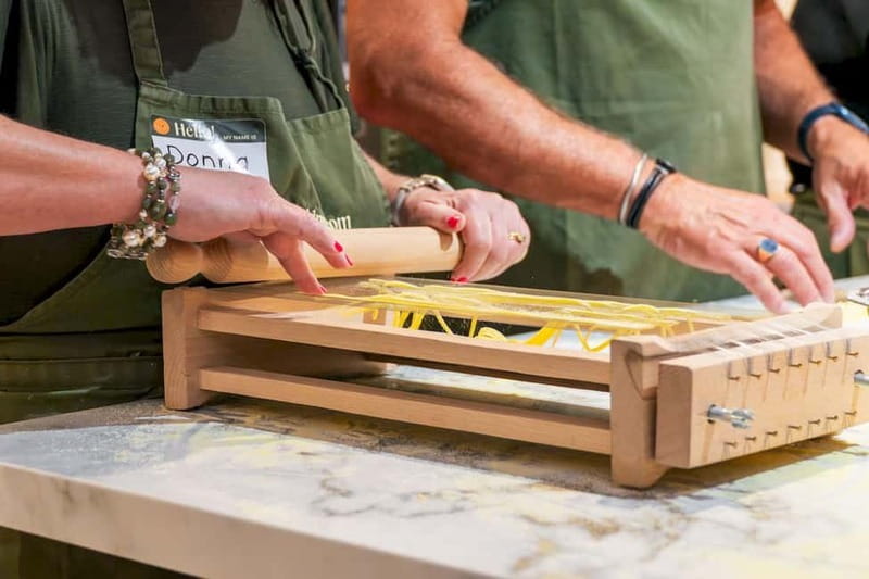 Rome: Hands-On Pasta & Tiramisu Class with Unlimited Wine - Mixing eggs and flour into fresh pasta