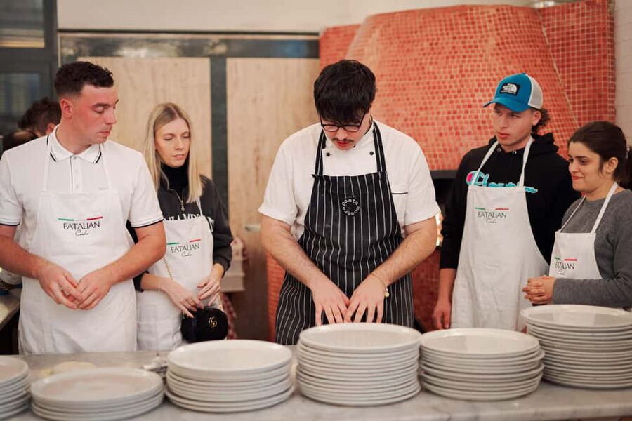 Rome: Pizza and Tiramisu Cooking Class in Piazza Navona - Rolling, topping, and baking your pizza